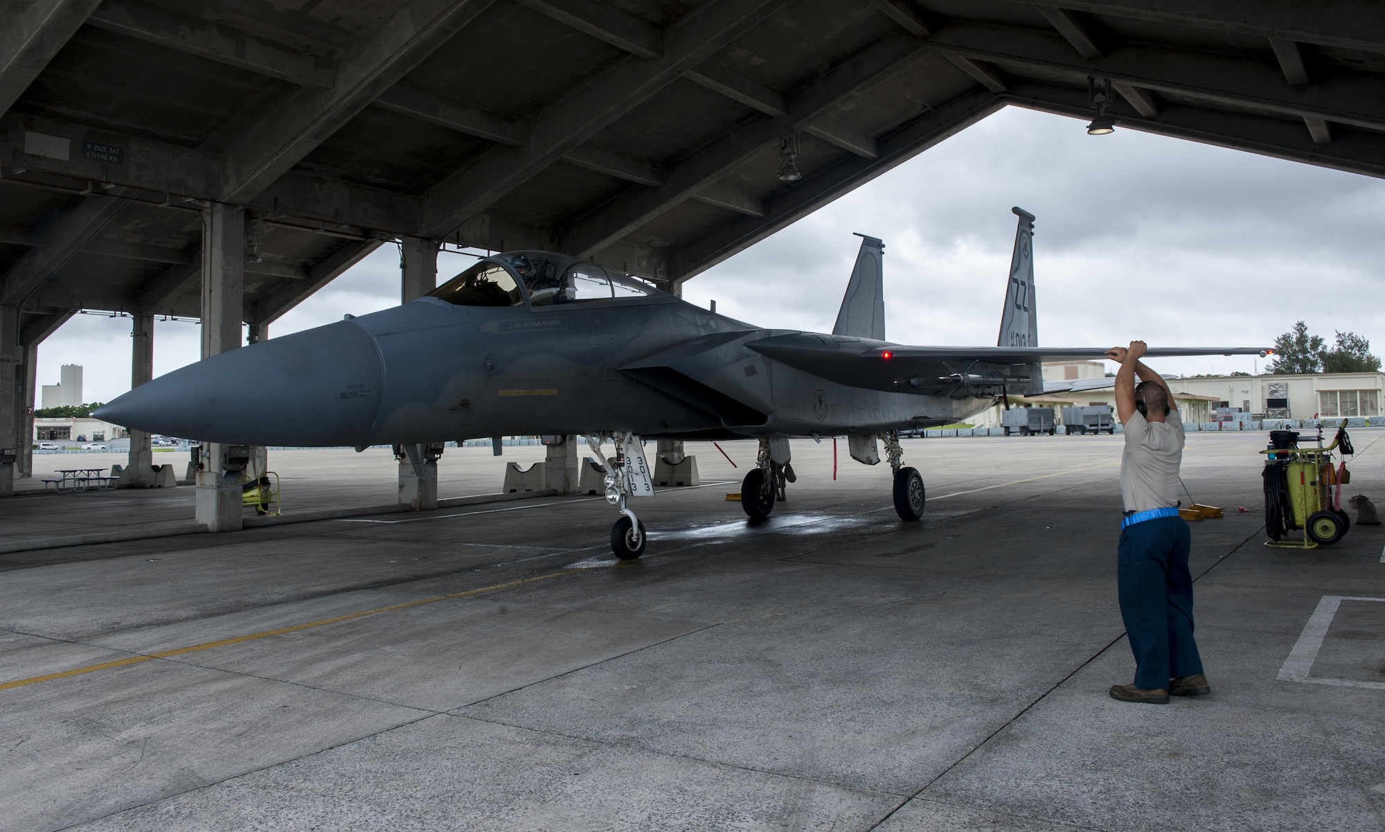 U.S. Air Force Senior Airman Devon Powell, 44th Aircraft Maintenance Unit dedicated crew chief, marshalls in an F-15C Eagle for maintanence, April 26, 2016, at Kadena Air Base Japan. After landing, each F-15C parks in a designated hangar for inspection and possible maintenance to be ready to fly again at a moment’s notice. (U.S. Air Force photo by Airman Zackary A. Henry)