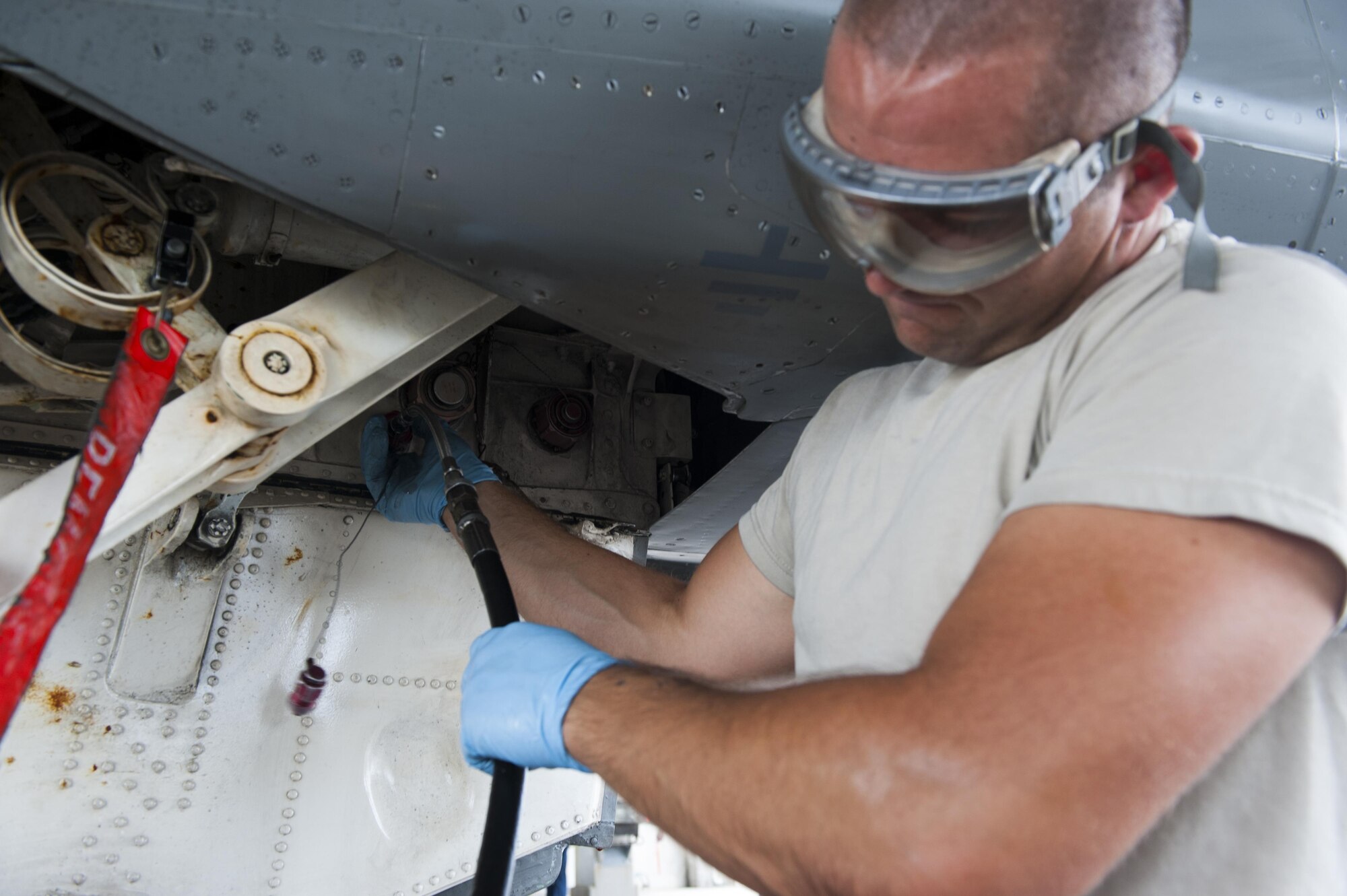 U.S. Air Force Senior Airman Devon Powell, 44th Aircraft Maintenance Unit dedicated crew chief, performs routine servicing on his F-15C Eagle, April 26, 2016, at Kadena Air Base Japan. As a dedicated crew chief Powell is assigned to an F-15C and is responsible for the day-to-day maintenance to ensure the fighter is ready at all times. (U.S. Air Force photo by Airman Zackary A. Henry)