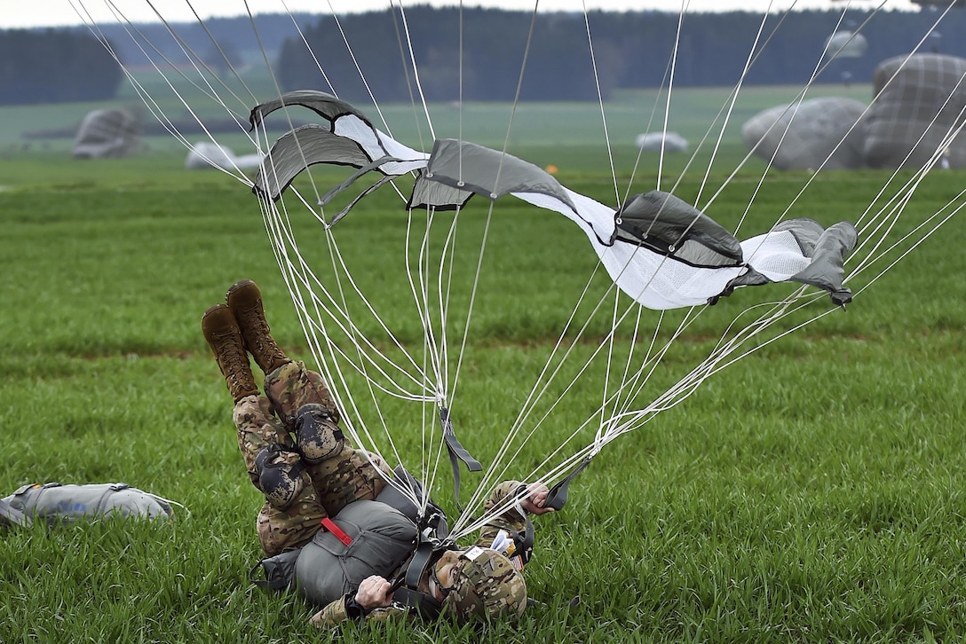 A paratrooper conducts a parachute landing fall during airborne operations as part of Exercise Saber Junction 16 near Grafenwoehr, Germany, April 12, 2016. Army photo by Gertrud Zach