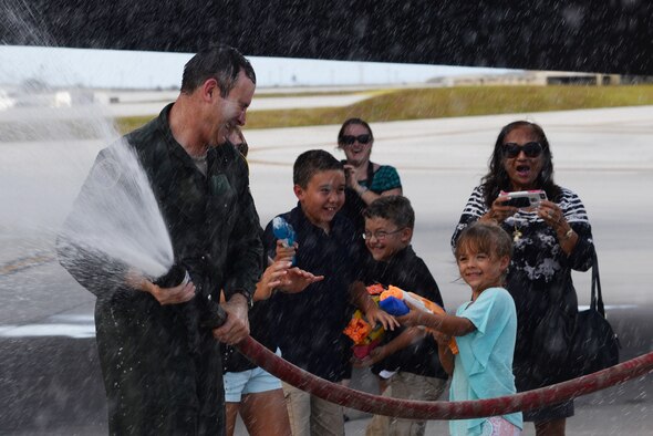 Brig. Gen. Andrew Toth, 36th Wing commander, celebrates with family and friends following his fini-flight April 26, 2016, at Andersen Air Force Base, Guam. The fini-flight is a time-honored military aviation tradition marking the last flight of a pilot's or commander's time with a unit. (U.S. Air Force photo by Airman 1st Class Jacob Skovo)