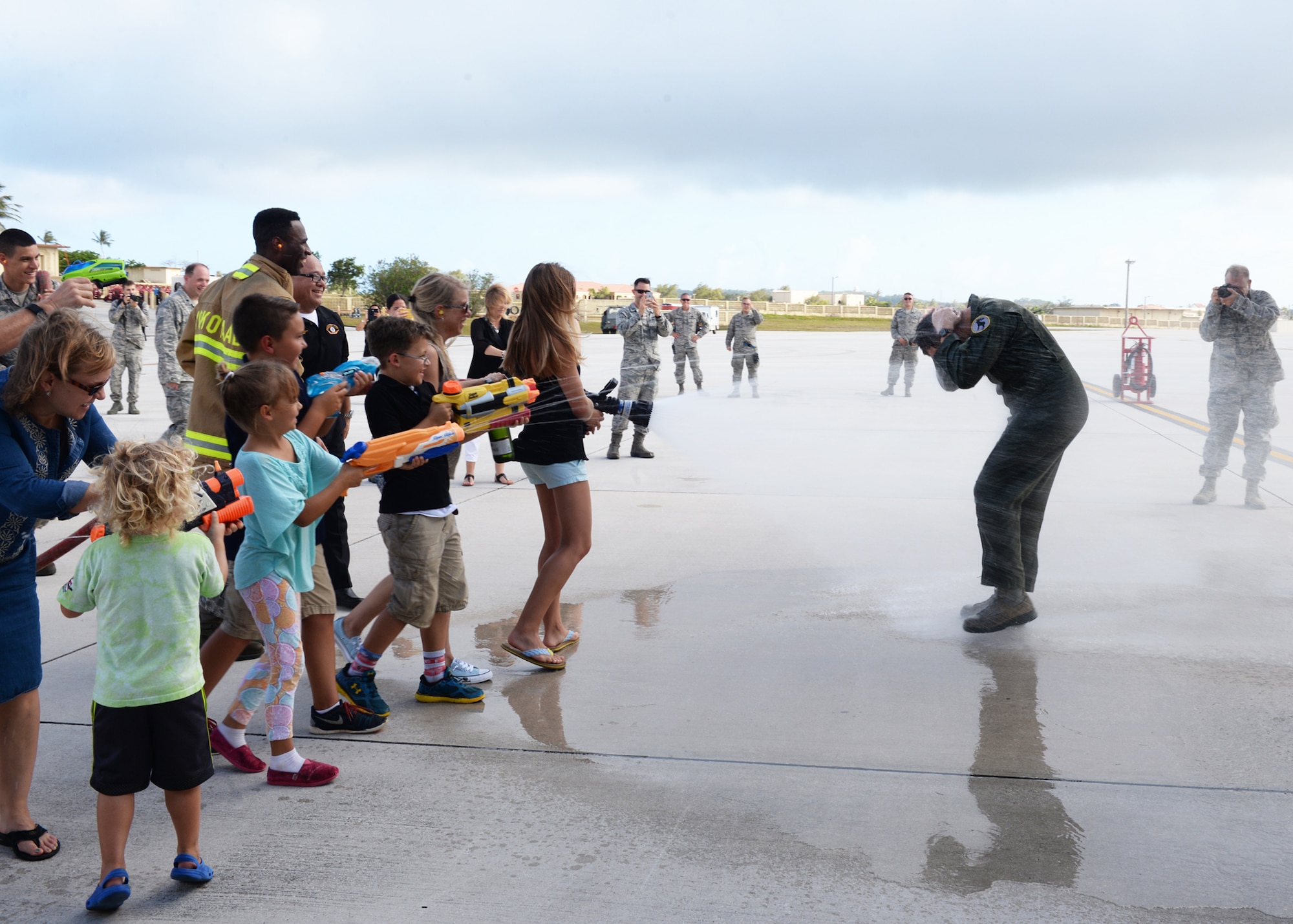 Brig. Gen. Andrew Toth, 36th Wing commander, is sprayed with water by friends and family after landing a B-52 Stratofortress during a fini-flight April 26, 2016, at Andersen Air Force Base, Guam. The fini-flight, which is a tradition carried throughout the Air Force, marks Toth’s final flight on Guam. (U.S. Air Force photo by Senior Airman Cierra Presentado)