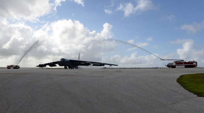 Fire trucks spray water on a B-52 Stratofortress piloted by Brig. Gen. Andrew Toth; 36th Wing commander; to celebrate his fini-flight April 26; 2016; at Andersen Air Force Base; Guam. Aircraft and pilots are traditionally doused with water to celebrate the aviator’s flying career. (U.S. Air Force photo by Airman 1st Class Jacob Skovo)