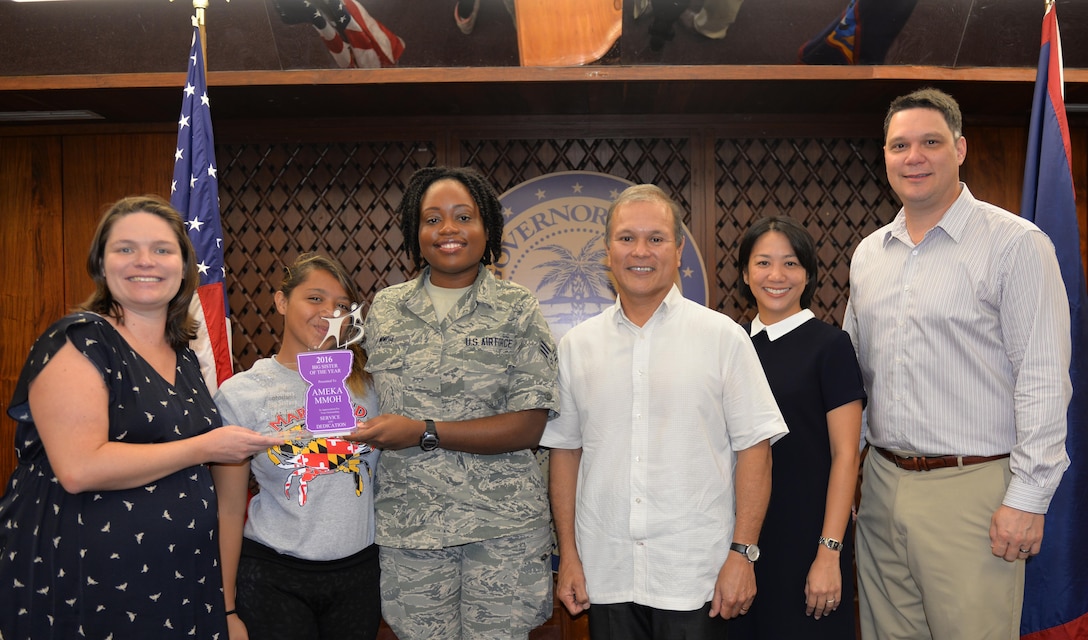 Senior Airman Ameka Mmoh, 36th Wing Public Affairs broadcast journalist, and her little sister Keiya pose stand for a photo while Mmoh accepts the 2016 Big Sister of the Year award from Big Brothers Big Sisters Guam Feb. 2, 2016, at the Governors Complex, Guam. Mmoh was given this award in appreciation for her outstanding service and dedication to her mentee, Keiya. (U.S. Air Force Photo/Capt. Joel Banjo-Johnson)