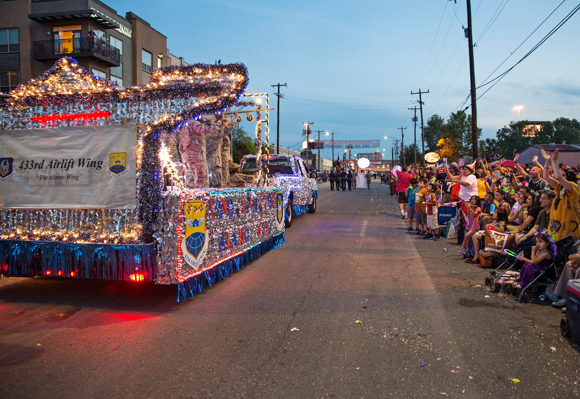 The 433rd Airlift Wing float travels down the Fiesta Flambeau parade route April 23, 2016. The Fiesta Flambeau parade is one of the largest illuminated parades in the world, with over 750,000 spectators and 1.5 million television viewers. (U.S. Air Force photo by Benjamin Faske) (released)