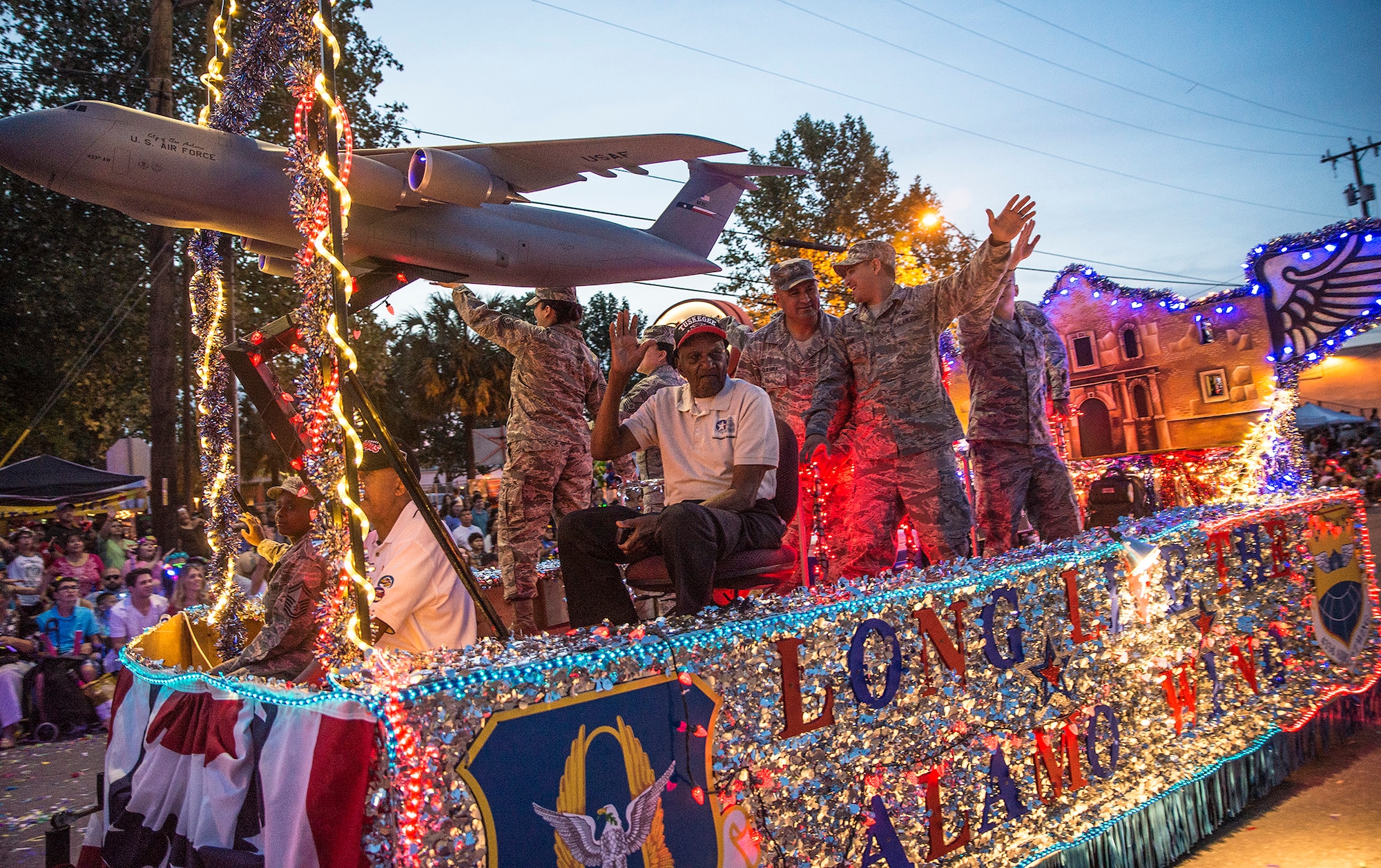 Theodore Johnson, a documented original Tuskegee Airman and San Antonio resident, waves to the crowd while riding on the 433rd Airlift Wing float during the Fiesta Flambeau parade April 23, 2016. (U.S. Air Force photo by Benjamin Faske) (released)