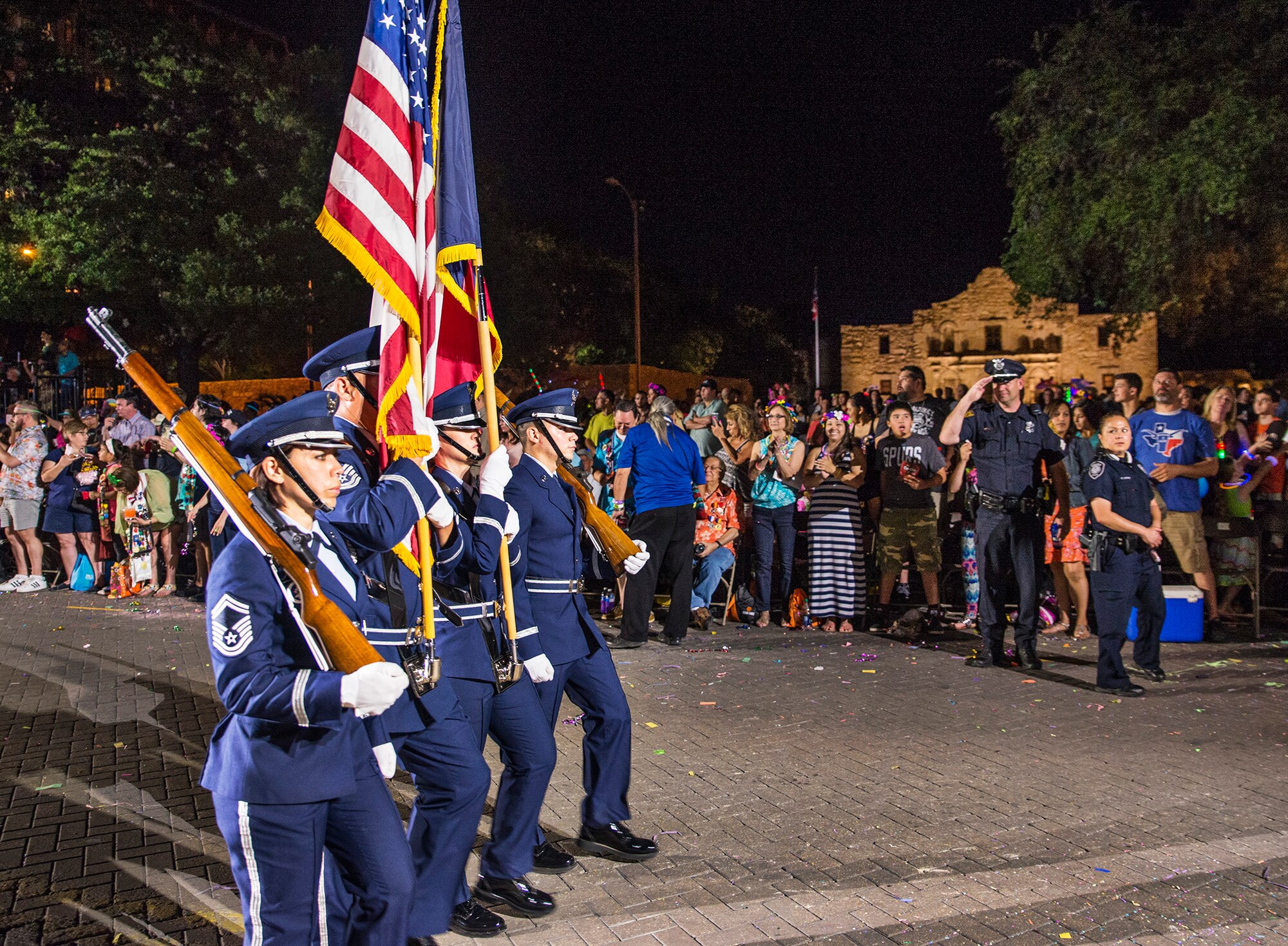 The 433rd Airlift Wing Honor Guard marches past the Alamo during the Fiesta Flambeau parade April 23, 2016. The Fiesta Flambeau parade is one of the largest illuminated parades in the world, with over 750,000 spectators and 1.5 million television viewers.  (U.S. Air Force photo by Benjamin Faske) (released)