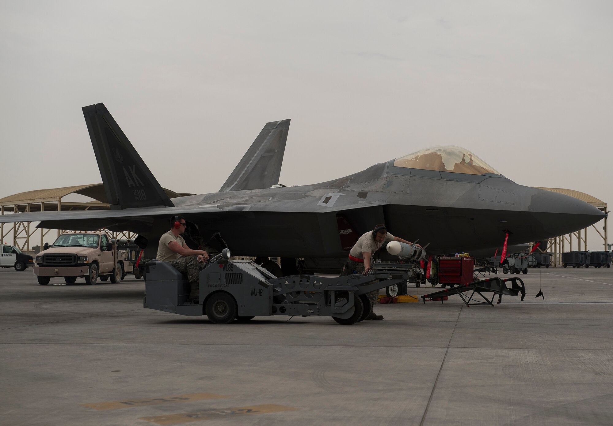 380th Air Expeditionary Wing Airmen download weapons from an F-22A Raptor at an undisclosed location in Southwest Asia April 14, 2016. The current group of Raptors employs the most up-to-date software and hardware package, allowing it to carry a wider range of munitions. (U.S. Air Force Photo by Staff Sgt. Chad Warren/Released)