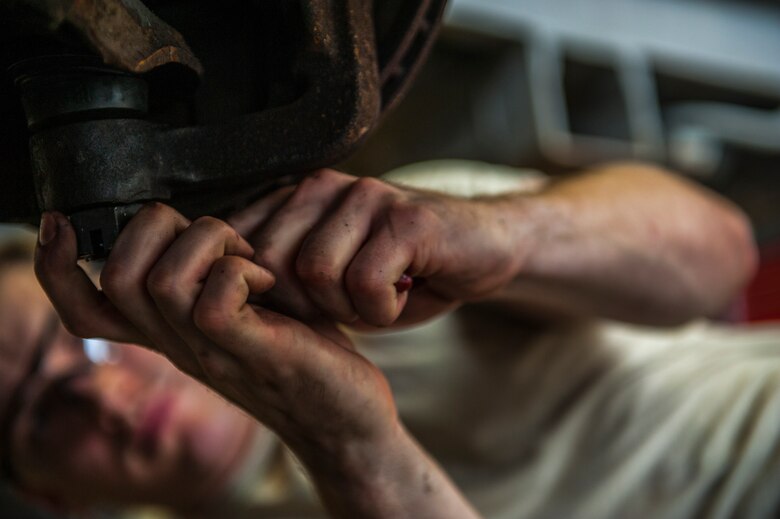 U.S. Air Force Airman 1st Class William Leonard, 18th Logistics Readiness Squadron vehicle mechanic, tightens a lug-nut during a ball joint replacement in the special vehicles shop April 14, 2016, at Kadena Air Base, Japan. The 18th LRS is responsible for all government owned vehicles on Kadena as well as their maintenance. (U.S. Air Force photo by Airman 1st Class Nick Emerick)