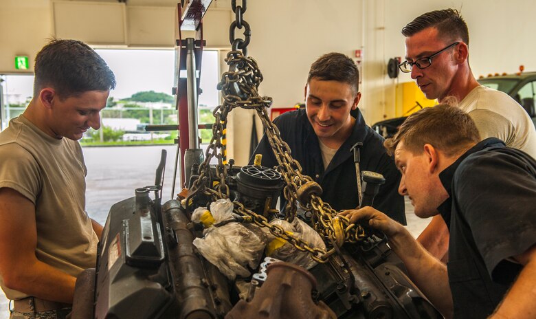 U.S. Air Force Airmen in the special vehicle maintenance shop with the 18th Logistics Readiness Squadron examine an engine after removing it from a truck April 26, 2016, at Kadena Air Base, Japan. The Vehicle Management Flight maintains more than 2,000 vehicles valued at $140 million. (U.S. Air Force photo by Airman 1st Class Nick Emerick)