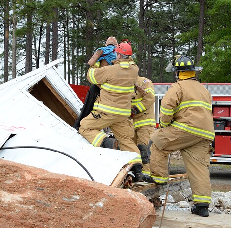 Firefighters from various fire departments throughout the area rescue a simulated injured victim during Exercise Black Swan 2016 aboard Marine Corps Logistics Base Albany, April 12.