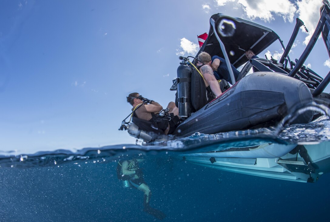 Navy Lt. Ryan Snow prepares to enter the water during a joint diving exercise with Sri Lankan sailors in Apra Harbor, Guam, April 13, 2016. Snow is assigned to Explosive Ordnance Disposal Mobile Unit 5. Navy photo by Petty Officer 3rd Class Alfred A. Coffield