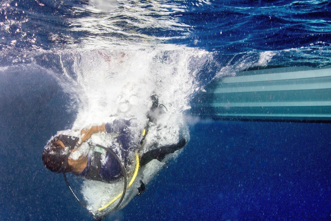 A Sri Lankan sailor enters the water during a joint diving exercise with U.S. sailors in Apra Harbor, Guam, April 13, 2016. Navy photo by Petty Officer 3rd Class Alfred A. Coffield