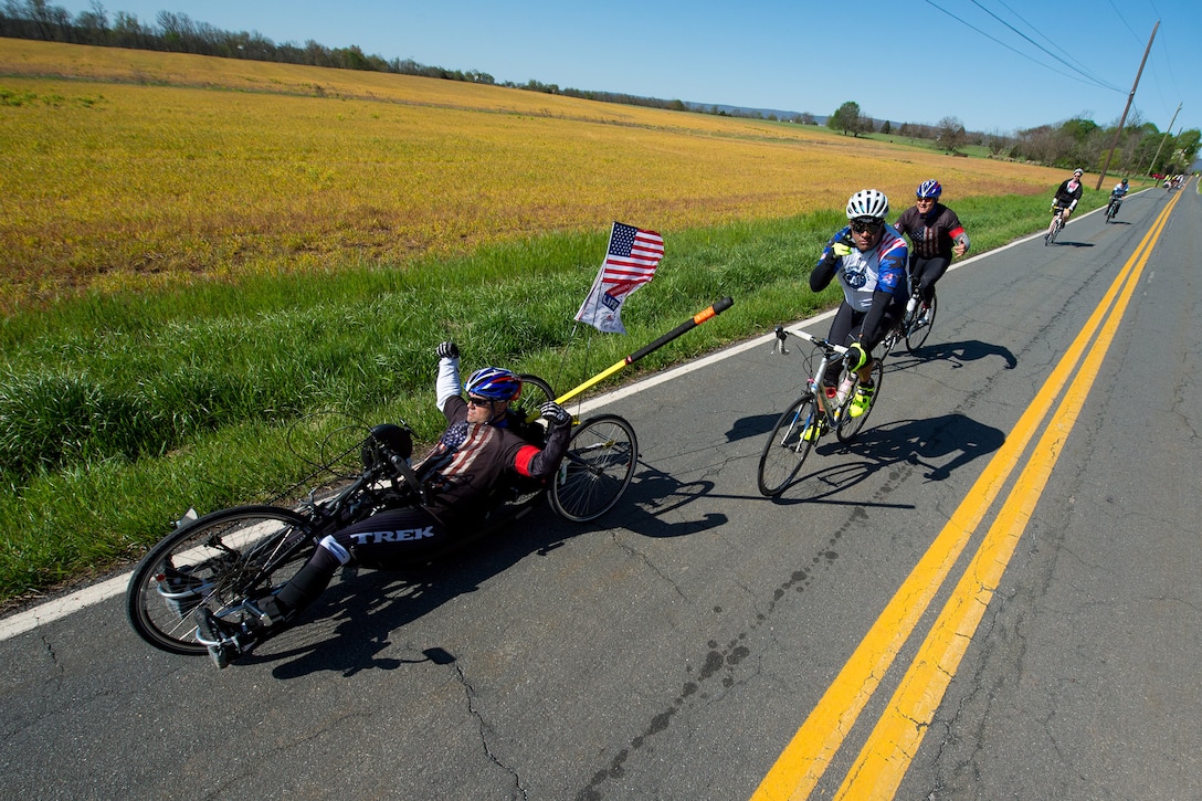 Retired Navy Petty Officer 1st Class Jerry Padgett II, front, sets a pace for his team during the Face of America bike ride in Gettysburg, Pa., April 24, 2016. More than 150 disabled veteran cyclists were paired among 600 able-bodied cyclists to ride 110 miles from Arlington, Va., to Gettysburg over two days in honor of veterans and military members. DoD photo by EJ Hersom