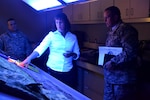 Ardra Farally, a chemist and shade evaluator at the DLA Product Test Center in Philadelphia, discusses the shade evaluation process for military uniforms to Army Sgt. Maj. Rodger Mansker of the Army’s operations and logistics readiness directorate.