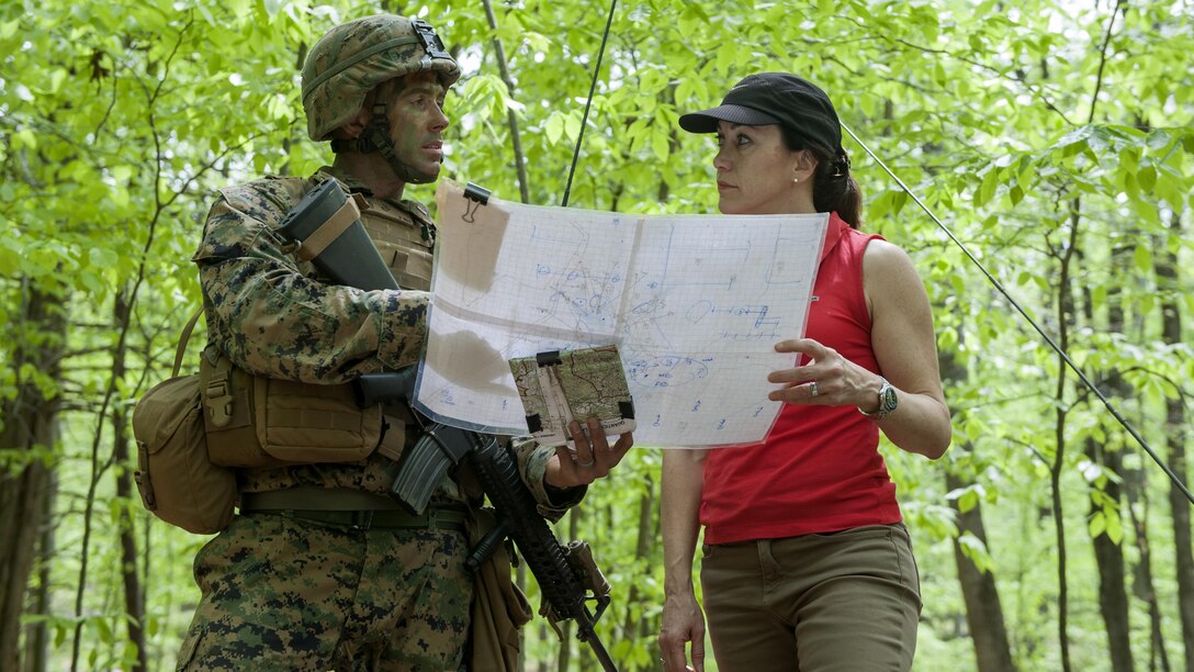 Under Secretary of the Navy Dr. Janine Davidson receives a brief from 2nd Lt. Scott R. Pierce, a student at The Basic School, on his platoon's defensive position in a training area at Marine Corps Base Quantico, Virginia, April 26, 2016. Davidson met with Marine Corps Combat Development Command leadership and Marines at TBS to better understand how the service trains, educates and equips its force.