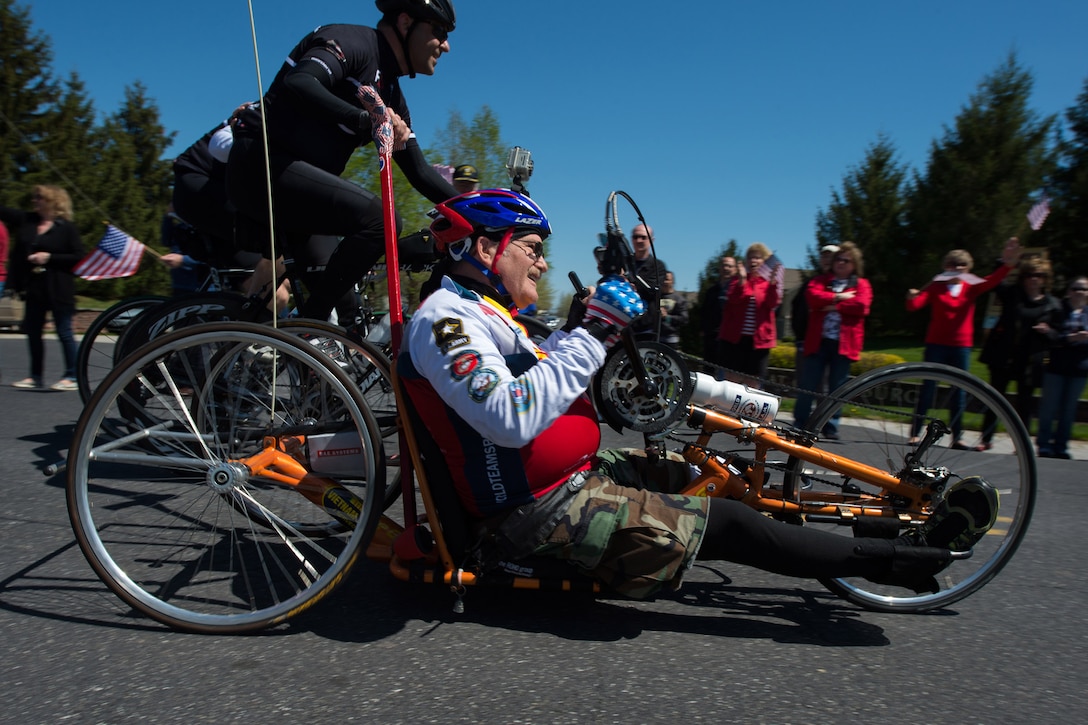 Vietnam War Army veteran Bill Czyzewski rides a recumbent bicycle to the applause of a crowd in Gettysburg, Pa., April 24, 2016. More than 150 disabled veteran cyclists were paired amongst 600 able-bodied cyclists to ride 110 miles from Arlington, Va., to Gettysburg over two days in honor of veterans and military members. DoD photo by EJ Hersom