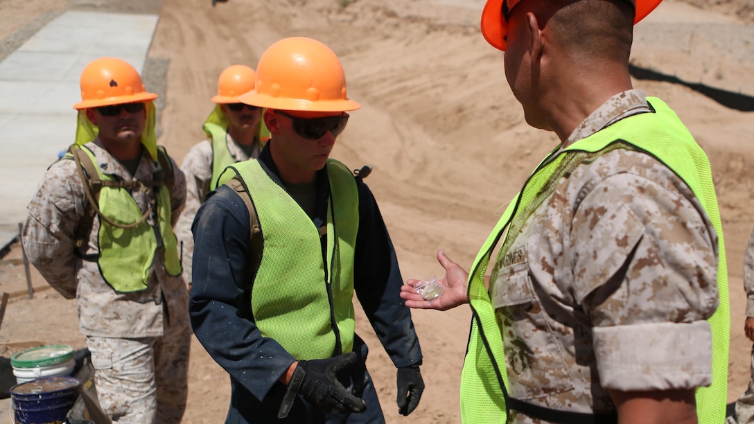 U.S. Marine Col. Ladaniel Dayzie presents a Marine from 7th Engineer Support Battalion with a challenge coin in El Centro, California, April 19, 2016. Dayzie is the deputy commander of Joint Task Force North in El Centro. Marines with 7th ESB assisted in a road improvement project with JTF-N during the months of March and April. During the project, the Marines have been processing and leveling dirt to improve the road’s quality as well as constructing low-water crossings to maintain the integrity of the road during wet conditions.