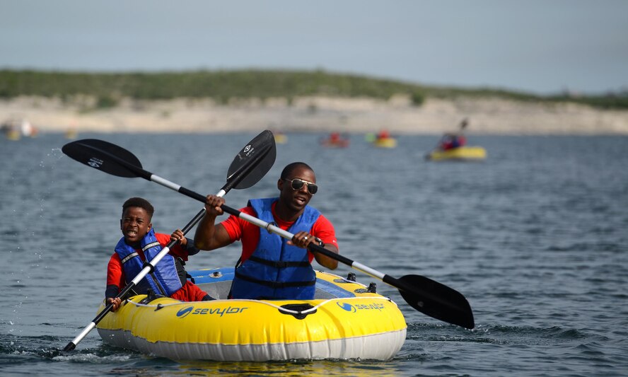 Maj. Willie Allen, front, 434th Flying Training Squadron director of operations, and his son David Allen, paddle in a raft during the 12th annual Adventure Race at the Laughlin Southwinds Marina near Del Rio, Texas, April 23, 2016. Nearly 200 people from Val Verde County and surrounding cities participated in the Adventure Race, which included up to a 4-mile run with mystery challenges, a 23-mile bicycle ride and a mile-long water rafting portion. (U.S. Air Force photo by Senior Airman Ariel D. Partlow)