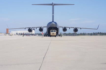 A C-17 Globemaster III lands at Joint Forces Training Base Los Alamitos, Calif., while ground crew conducts a "cold offload" of a Light Medium Tactical Vehicle during  Operation Patriot Hook, April 23, 2016. Operation Patriot Hook is a joint service and inter-agency exercise which partners local military branches with members of local, federal, and state agencies to practice their combined response procedures in case of major regional disasters such as earth quakes, riots, or fires. In its 29th year as an
exercise, agencies involved in this year's Operation Patriot Hook included the U.S. Army Reserve, the U.S. Air Force Reserve, the Department of Homeland Security, and the FBI. (U.S. Army Photo by Sgt. 1st Class Alexandra Hays, 201st Press Camp Headquarters).