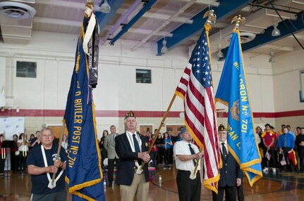 The American Legion Post 701, of White Oak, Pa., color guard presents the colors during the playing of the National Anthem during a ceremony for Staff Sgt. Michelle Satterfield in McKeesport, Pa., April 25, 2016. Satterfield is receiving a house built by the students of the McKeesport Area High School and Stephen Siller Tunnel to Towers Foundation for all of the volunteer work she has done in the past years. (U.S. Army photo by Staff Sgt. Dalton Smith / Released)