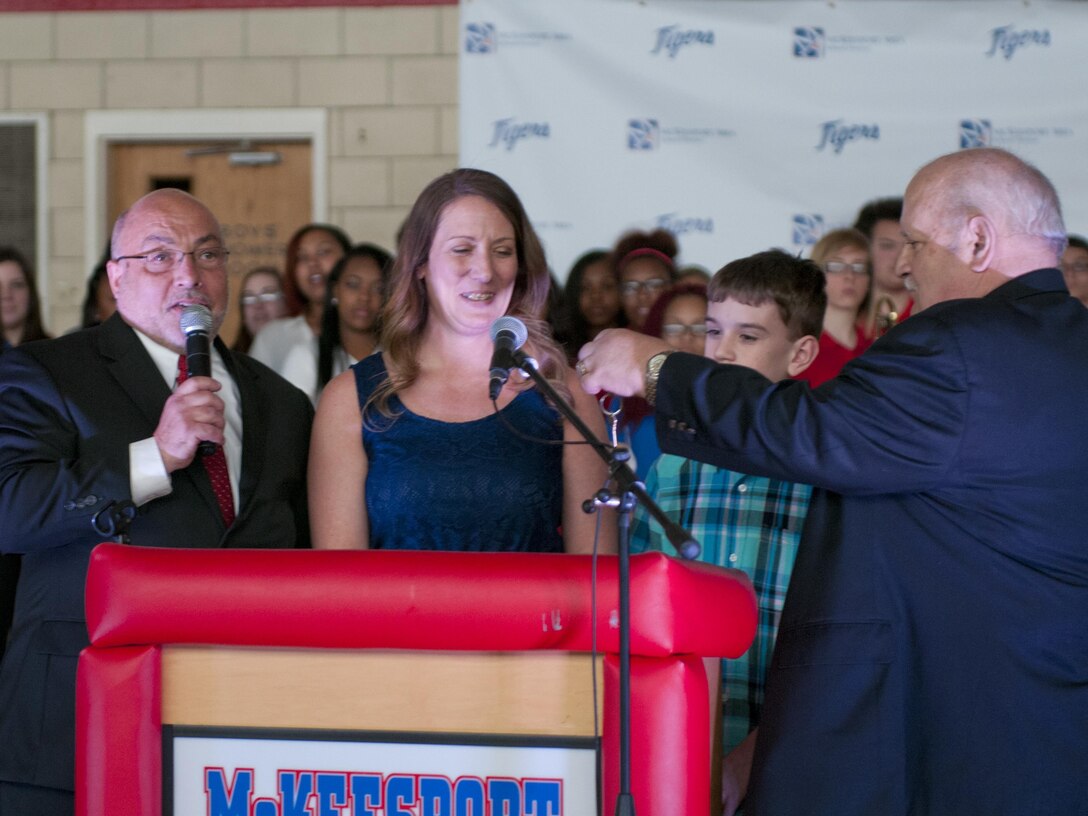 John Bertoty, of Blue Roof Technologies, hand keys to Staff Sgt. Michelle Satterfield, with the 14th Quartermaster Detachment, for her new house during the ceremony for her in McKeesport, Pa., April 25, 2016. Satterfield is receiving a house built by the students of the McKeesport Area High School and Stephen Siller Tunnel to Towers Foundation for all of the volunteer work she has done in the past years. (U.S. Army photo by Staff Sgt. Dalton Smith / Released)