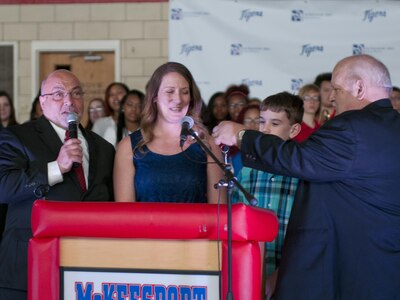John Bertoty, of Blue Roof Technologies, hand keys to Staff Sgt. Michelle Satterfield, with the 14th Quartermaster Detachment, for her new house during the ceremony for her in McKeesport, Pa., April 25, 2016. Satterfield is receiving a house built by the students of the McKeesport Area High School and Stephen Siller Tunnel to Towers Foundation for all of the volunteer work she has done in the past years. (U.S. Army photo by Staff Sgt. Dalton Smith / Released)