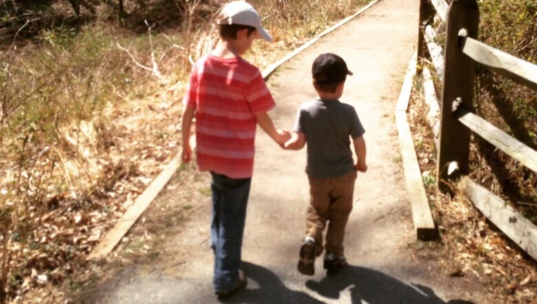 Dawson Stock (right) takes a walk with his brother, Gavin Stock (left). Dawson was diagnosed with autism weeks before his 3rd birthday. He is currently enrolled in speech therapy, occupational therapy and applied behavior analysis through TRICARE. (Courtesy Photo)