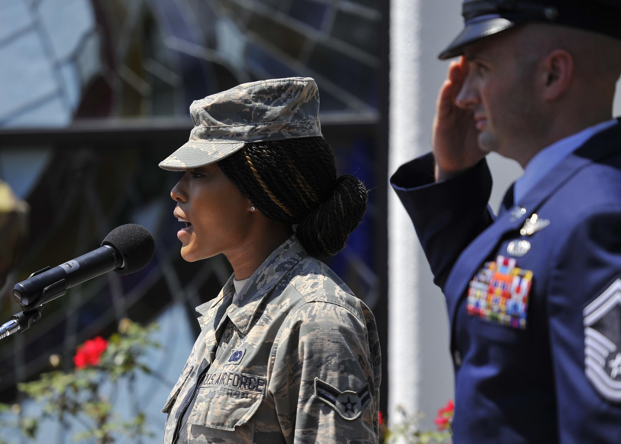 Senior Master Sgt. Kevin Forrest, the superintendent of the 8th Special Operations Squadron, renders a salute while Airman 1st Class Morgan Mclin, a central storage journeyman with the 1st Special Operations Logistics Readiness Squadron, sings the national anthem during a ceremony for the 36th anniversary of Operation Eagle Claw at Hurlburt Field, Fla., April 25, 2016. Operation Eagle Claw, the attempted rescue mission of American hostages from the United States embassy in Iran, ended in disaster at the Desert One refueling site in April 1980. Eight American service members were killed during the mission, resulting in the Holloway Commission to convene and analyze why the mission failed. The recommended corrective actions led to the gradual reorganization and rebirth of United States Special Operations Command in 1987. (U.S. Air Force photo Airman 1st Class Kai White)