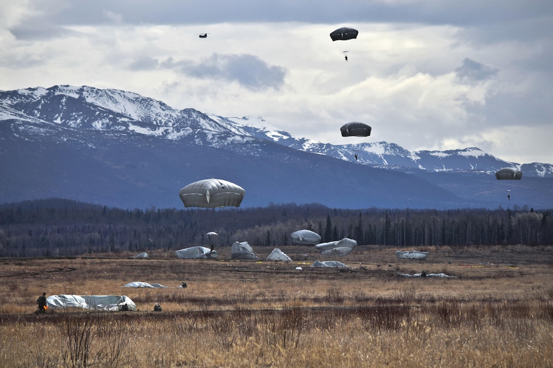 Paratroopers jump from a CH-47 Chinook helicopter during an airborne operation onto Malemute drop zone at Joint Base Elmendorf-Richardson, Alaska, April 14, 2016. The paratroopers are assigned to the 25th Infantry Division’s 4th Brigade Combat Team (Airborne). They partnered with soldiers assigned to Company B, 1st Battalion, 52nd Aviation Regiment during the jump. Army photo by Staff Sgt. Brian K. Ragin Jr.