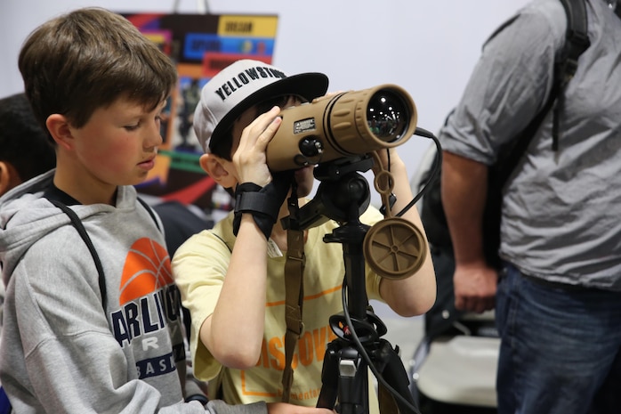 A child looks through the Medium Range Thermal Bi-ocular during the USA Science & Engineering Festival April 14–17 in Washington, DC. The MRTB was one of the items Marine Corps Systems Command showcased at its exhibit booth. This year marked MCSC’s second year participating in the festival as part of an ongoing effort to partner with other government agencies, academic institutions and private industry to improve STEM education in the United States.  (U.S. Marine Corps photo by Mathuel Browne)