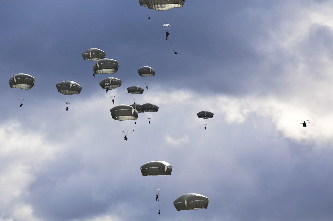 Paratroopers descend over Malemute drop zone during an airborne operation at Joint Base Elmendorf-Richardson, Alaska, April 14, 2016. Army photo by Staff Sgt. Brian K. Ragin Jr.