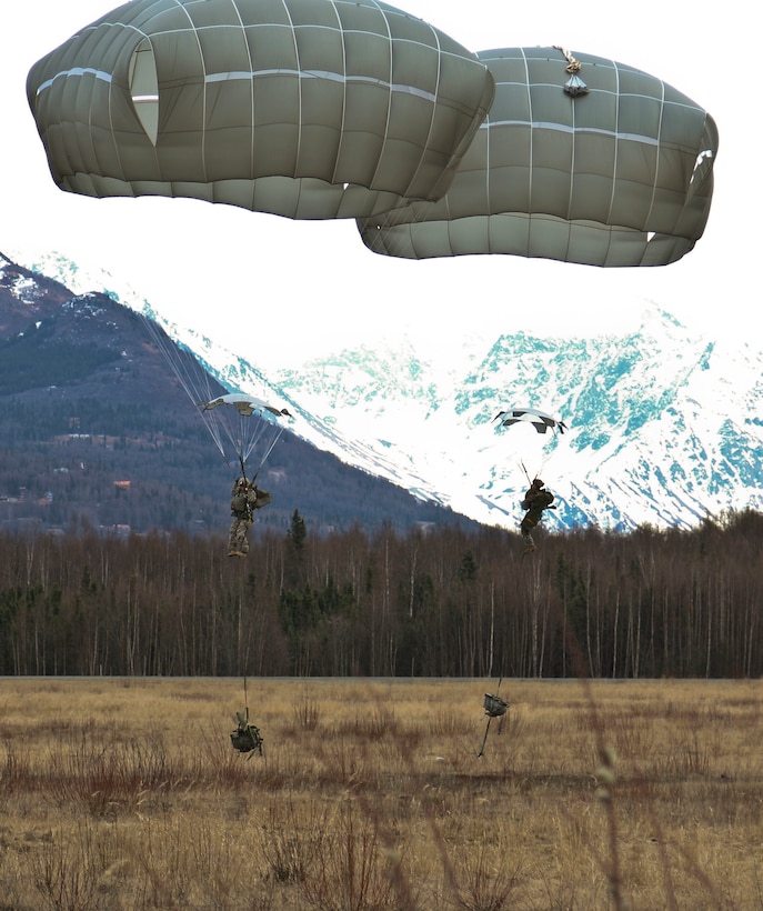 Two paratroopers prepare to land during an airborne operation onto Malemute drop zone at Joint Base Elmendorf-Richardson, Alaska, April 14, 2016. Army photo by Staff Sgt. Brian K. Ragin Jr.