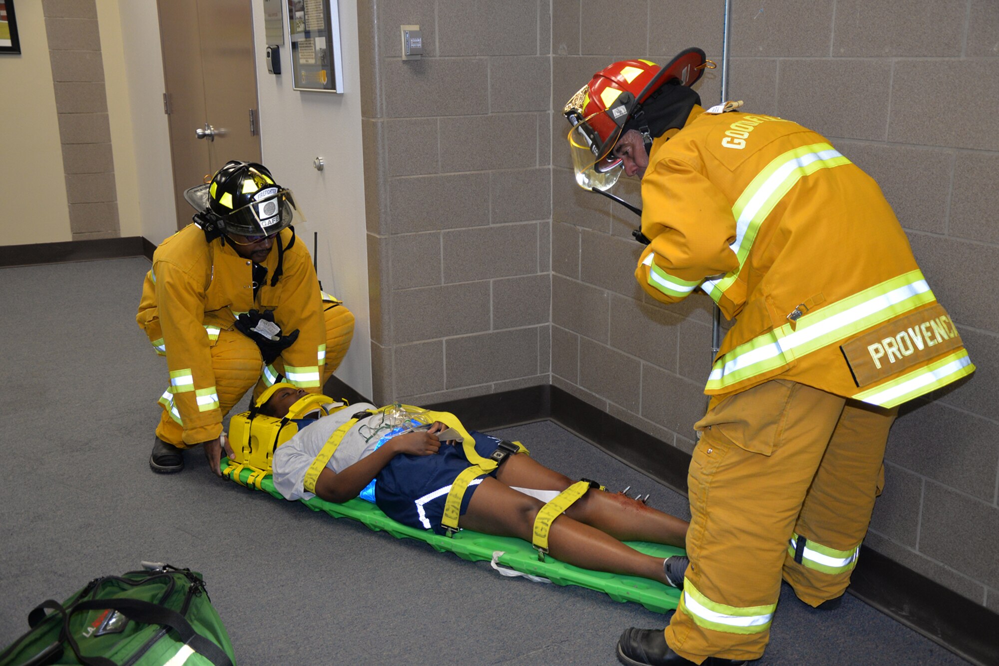 Firefighters from the 17th Civil Engineer Squadron Fire Emergency Services treat simulated wounds on U.S. Air Force Airman 1st Class Connie L. Brown, 315th Training Squadron student, during an exercise on Goodfellow Air Force Base, Texas, April 21, 2016. Airmen used make-up to simulate wounds they received from the tornado. (U.S. Air Force photo by Airman 1st Class Randall A.S. Moose/Released)