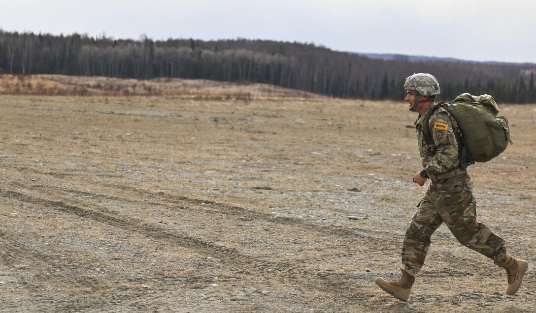 Army Staff Sgt. William Parker runs to a rally point after participating in an airborne operation onto Malemute drop zone at Joint Base Elmendorf-Richardson, Alaska, April 14, 2016. Parker is assigned to the 25th Infantry Division’s 725th Brigade Support Battalion, 4th Infantry Brigade Combat Team (Airborne). Army photo by Staff Sgt. Brian K. Ragin Jr.