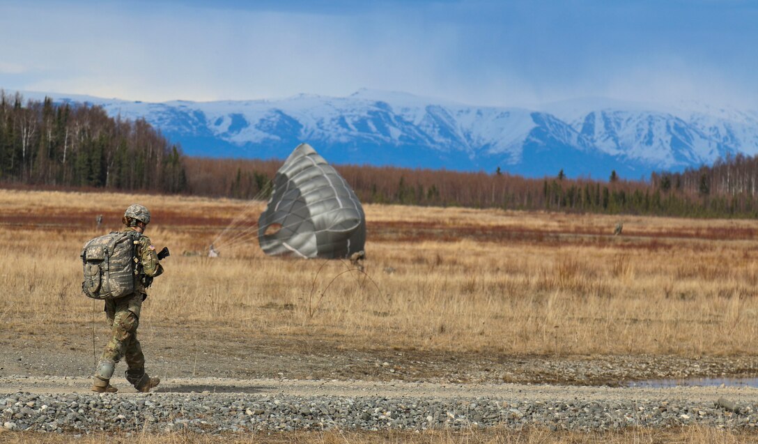 A paratrooper marches to a rally point after participating in an airborne operation onto Malemute drop zone at Joint Base Elmendorf-Richardson, Alaska, April 14, 2016. Army photo by Staff Sgt. Brian K. Ragin Jr.