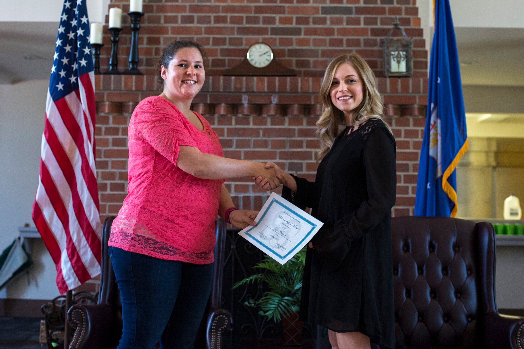 Emily Crossman, Moody Thrift Shop Board of Governors president, presents Liz Whitmer, wife of Airman 1st Class Matthew Whitmer, 723d Aircraft Maintenance Squadron, with a Scholarship of Merit, April 24, 2016, at Moody Air Force Base, Ga. Whitmer plans to attend Wiregrass Georgia Technical College to pursue a nursing degree. 
(U.S. Air Force photo by Airman Daniel Snider/Released)
