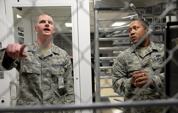 U.S. Air Force Staff Sgt. Robert Thomas, left, the 90th Communications Squadron NCO in charge of visual imagery and intrusion detection systems, discusses Whiteman’s fiber optic security system in the Air Force Global Strike Command’s electronic security systems training lab with Tech. Sgt. Dexter Gore, right, the 509th Communications Squadron NCO in charge of intrusion detection systems, at Whiteman Air Force Base, Mo., April 13, 2016. Eleven Airmen from the 90th Missile Wing spent six days at Whiteman exchanging information and ideas. 