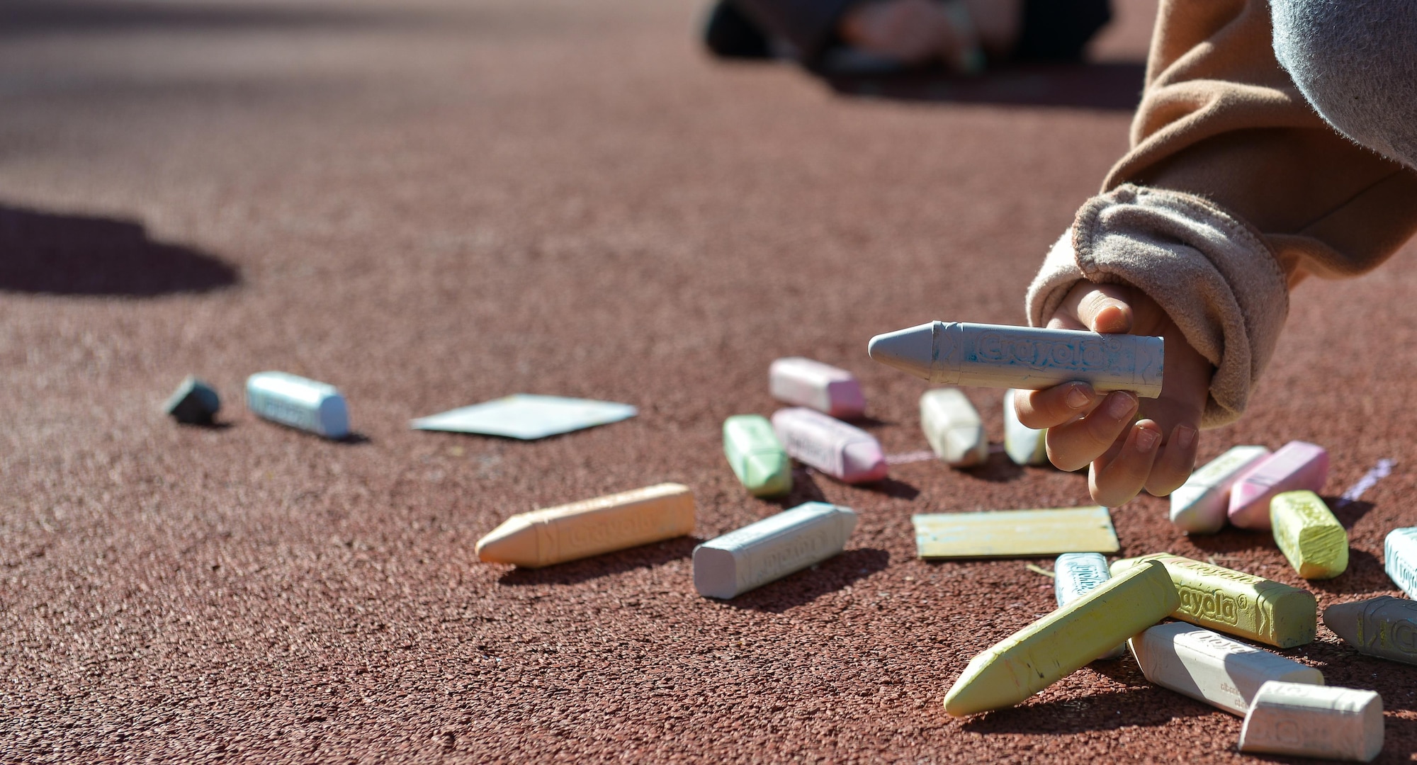 A child picks up a stick of chalk during a therapy session at Vogelweh Elementary School on April 21, 2016, at Vogelweh Air Base, Germany. Many children who had to leave Turkey and separate from family members serving there have been placed in new schools around the Kaiserslautern military community in Germany. While attending new schools, they undergo therapy to cope with stress and anxiety built up during the transition. (U.S. Air force photo/Airman 1st Class Lane T. Plummer)