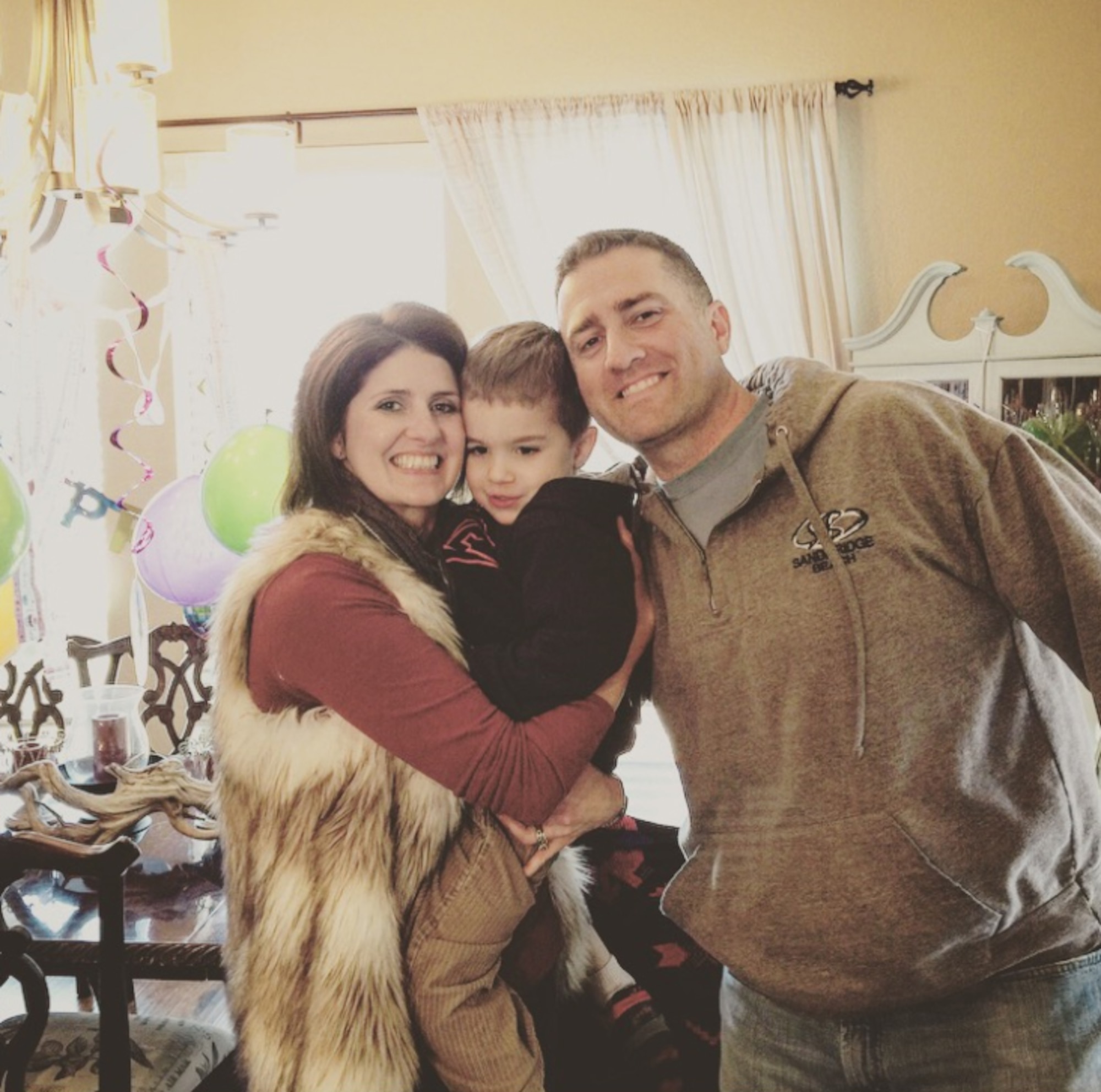 Dawson Stock, pictured here with his parents, Jennifer Stock and Maj. Michael Stock. Dawson was diagnosed with autism weeks before his 3rd birthday. He is currently enrolled in speech therapy, occupational therapy and applied behavior analysis through TRICARE. (Courtesy Photo)