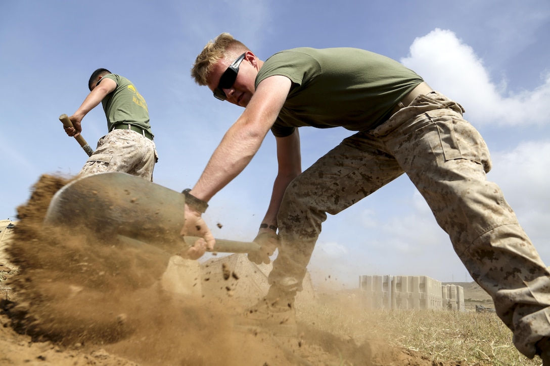 Marine Corps Lance Cpl. Seth A. Gordon digs a trench to conceal network cables as part of a Marine Expeditionary Unit exercise at Camp Pendleton, Calif., April 26, 2016. The exercise ensures communication and coordination among organic units. Marine Corps photo by Gunnery Sgt. Rome M. Lazarus