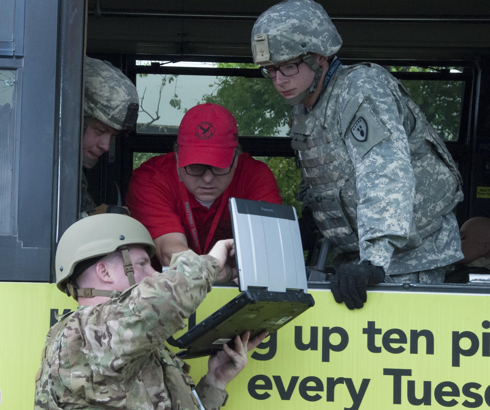 Tech. Sgt. Russell Szczepaniec, 301st Explosive Ordnance Disposal Flight technician, holds up a computer for his Army teammates and an exercise controller to view scenario information during the Raven's Challenge X April 20 at Fort Wolters, Texas. The exercise gives military EOD technicians, public safety bomb squads, and other government agencies the opportunity to merge their resources and perform counter-IED operations together in a realistic training environment. The exercise occurs in four different locations across the country making it the largest in the world of its kind. (U.S. Air Force photo by Staff Sgt. Melissa Harvey)