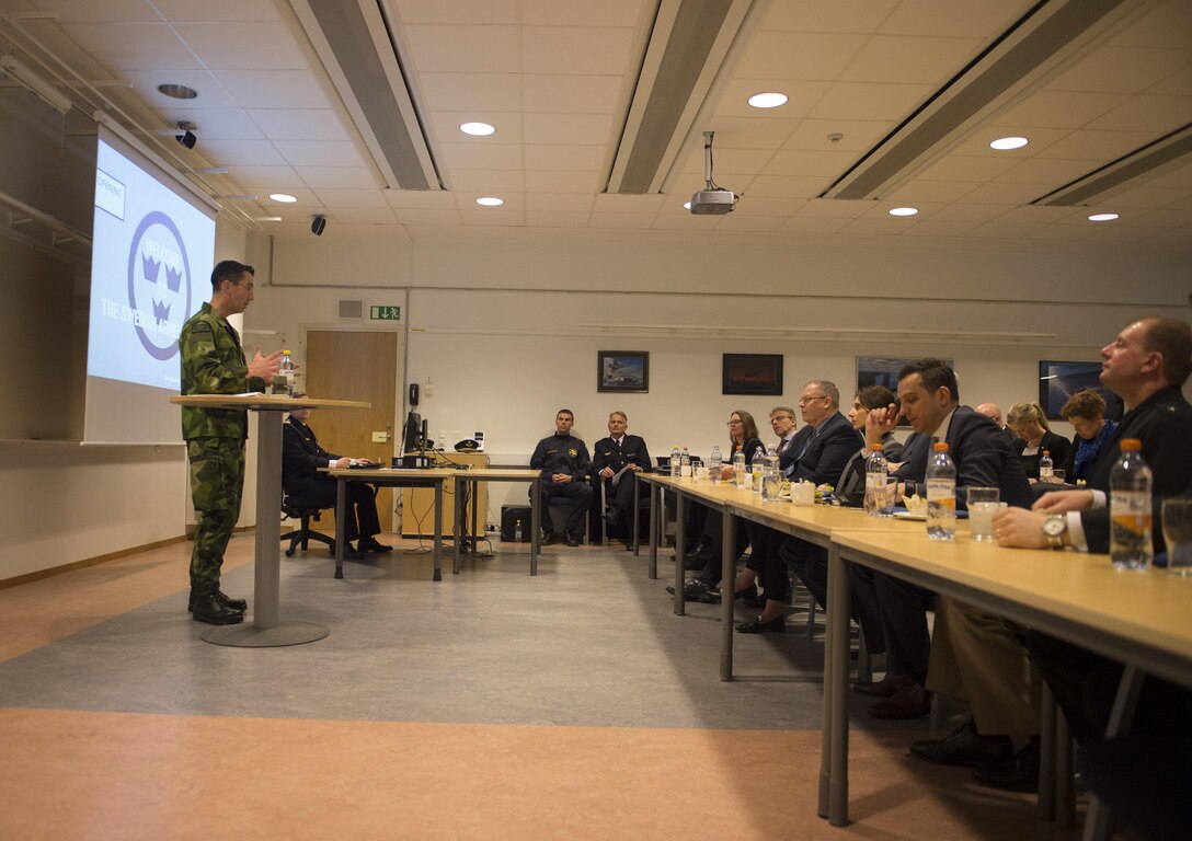 Deputy Defense Secretary Bob Work, seated, center front, listens to a briefing on the capabilities of the Swedish Air Force in Ronneby, Sweden, April 27, 2016. DoD photo by Navy Petty Officer 1st Class Tim D. Godbee