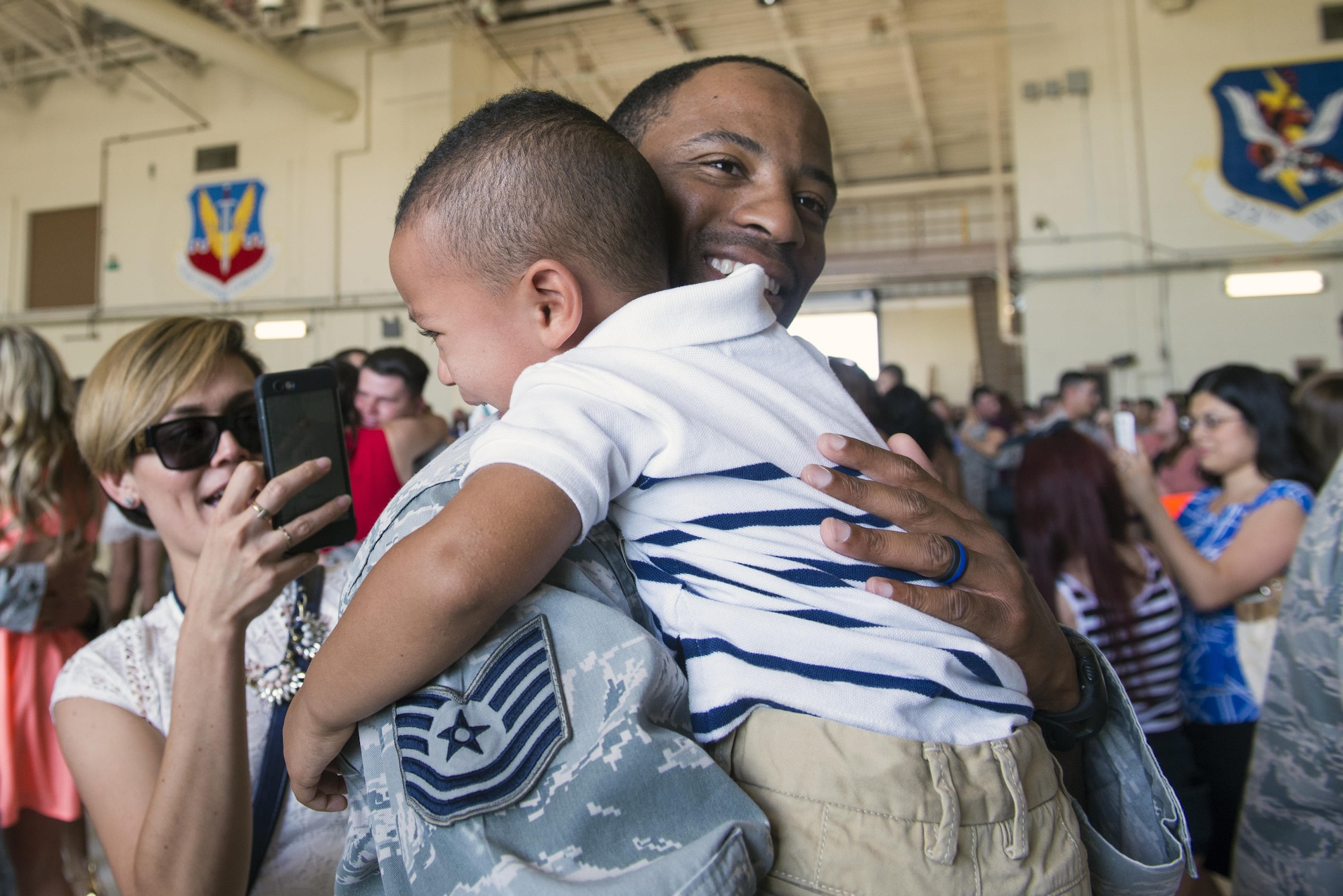 U.S. Air Force Tech. Sgt. Devant Jones, 824th Base Defense Squadron squad leader, embraces his son, Demari, after returning from a deployment, April 25, 2016, at Moody Air Force Base, Ga. The 824th BDS Airmen are ready to deploy at all times while maintaining combat and specialty training standards. (U.S. Air Force photo by Airman 1st Class Greg Nash/Released) 