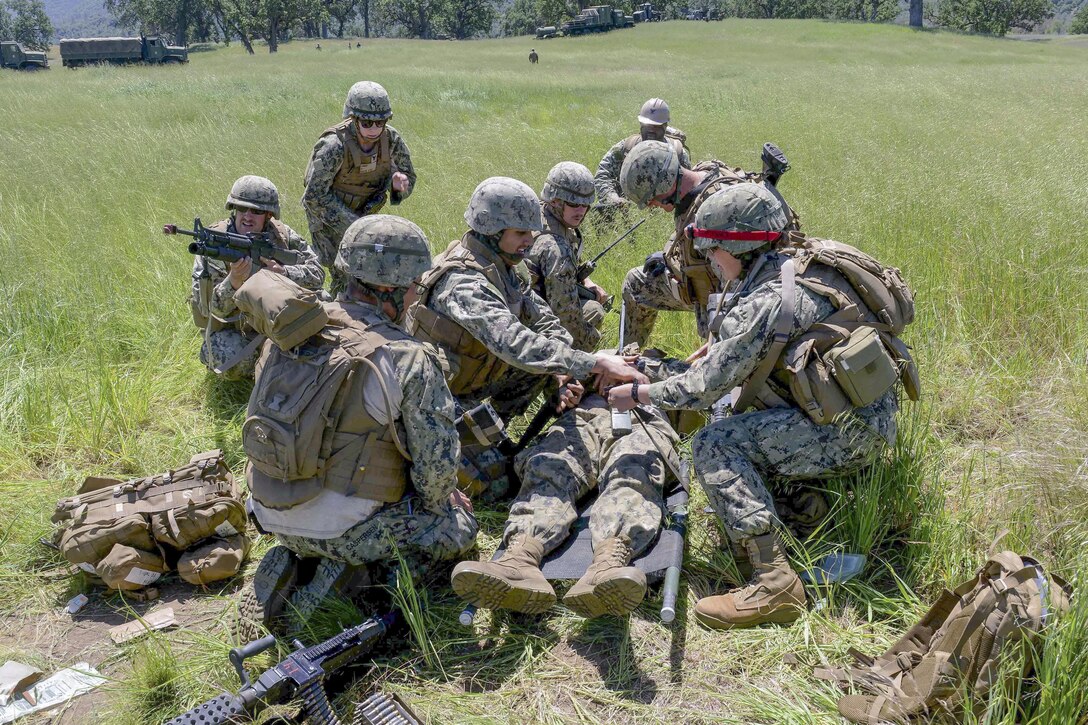 Navy Seabees participate in a mass casualty drill during the battalion’s field training exercise near Fort Hunter Liggett, Calif., April 25, 2016. The  Seabees are assigned  to Naval Mobile Construction Battalion 5. The exercise tests the battalion's ability to enter hostile locations, build assigned construction projects and defend against enemy attacks using realistic scenarios. Navy photo by Petty Officer 2nd Class Adam Henderson


