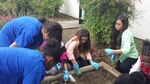 Members of the Joint Base San Antonio-Randolph Youth Programs' Torch Club plant flowers on the Youth Programs grounds April 19 for their Earth Day project.