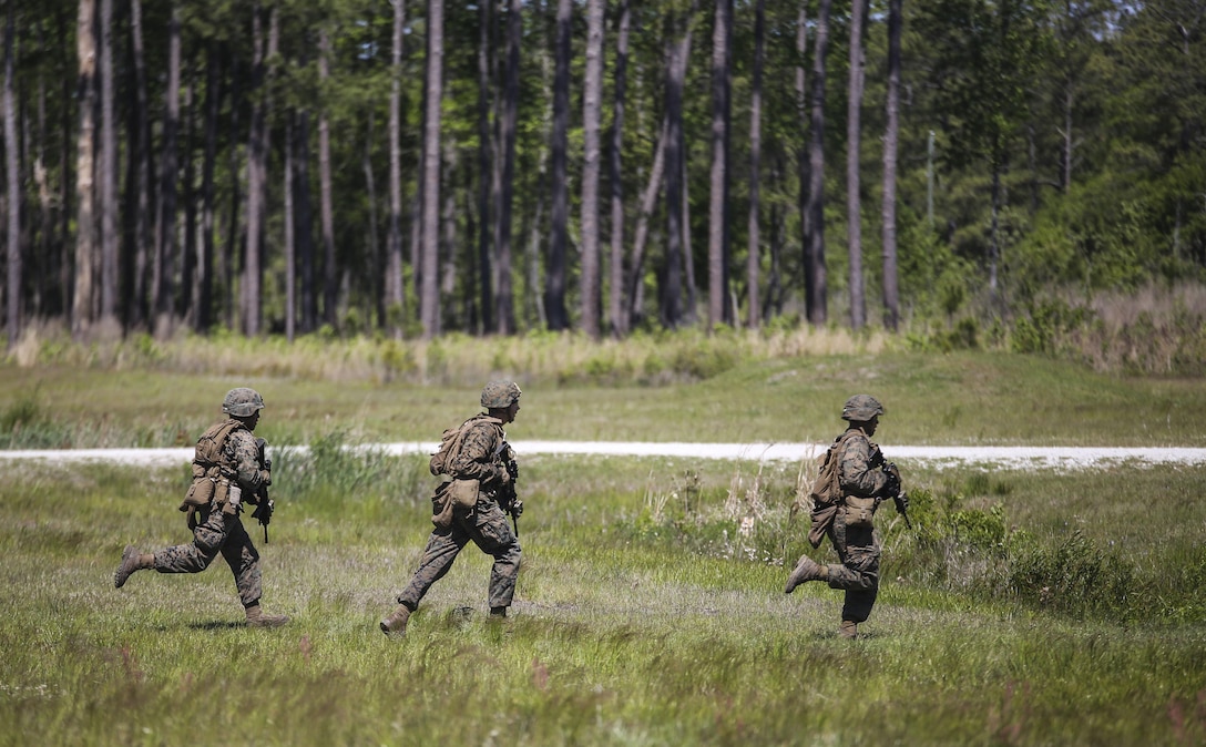 Marines with Kilo Company, 3rd Battalion, 8th Marine Regiment rush off of a training range during a fire-team attacks exercise as part of the battalion field exercise at Camp Lejeune, N.C., April 26, 2016. The unit is slated to conduct a training package at Marine Corps Mountain Warfare Training Center Bridgeport, Calif., in the coming months. (U.S. Marine Corps photo by Cpl. Paul S. Martinez/Released)