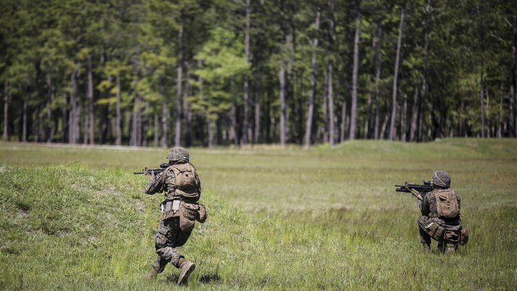 Marines with Kilo Company, 3rd Battalion, 8th Marine Regiment assault targets down range during a fire-team attack exercise as part of the battalion field exercise at Marine Corps Base Camp Lejeune, North Carolina, April 26, 2016. The FEX, now in the final week of operations, previously tested Marines on basic infantry fundamentals such as patrolling and land navigation.
