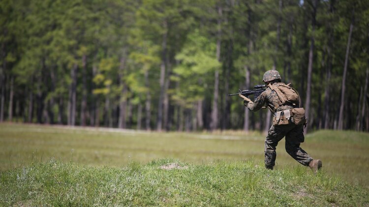 Pfc. Jacob T. Witt, a machine gunner with Kilo Company, 3rd Battalion, 8th Marine Regiment, moves down range during a fire-team attack exercise as part of the battalion field exercise at Marine Corps Base Camp Lejeune, North Carolina, April 26, 2016. The FEX, now in its final week of operations, previously tested Marines on basic infantry fundamentals such as patrolling and land navigation.