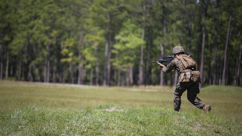 Pfc. Jacob T. Witt, a machine gunner with Kilo Company, 3rd Battalion, 8th Marine Regiment, moves down range during a fire-team attack exercise as part of the battalion field exercise at Marine Corps Base Camp Lejeune, North Carolina, April 26, 2016. The FEX, now in its final week of operations, previously tested Marines on basic infantry fundamentals such as patrolling and land navigation.
