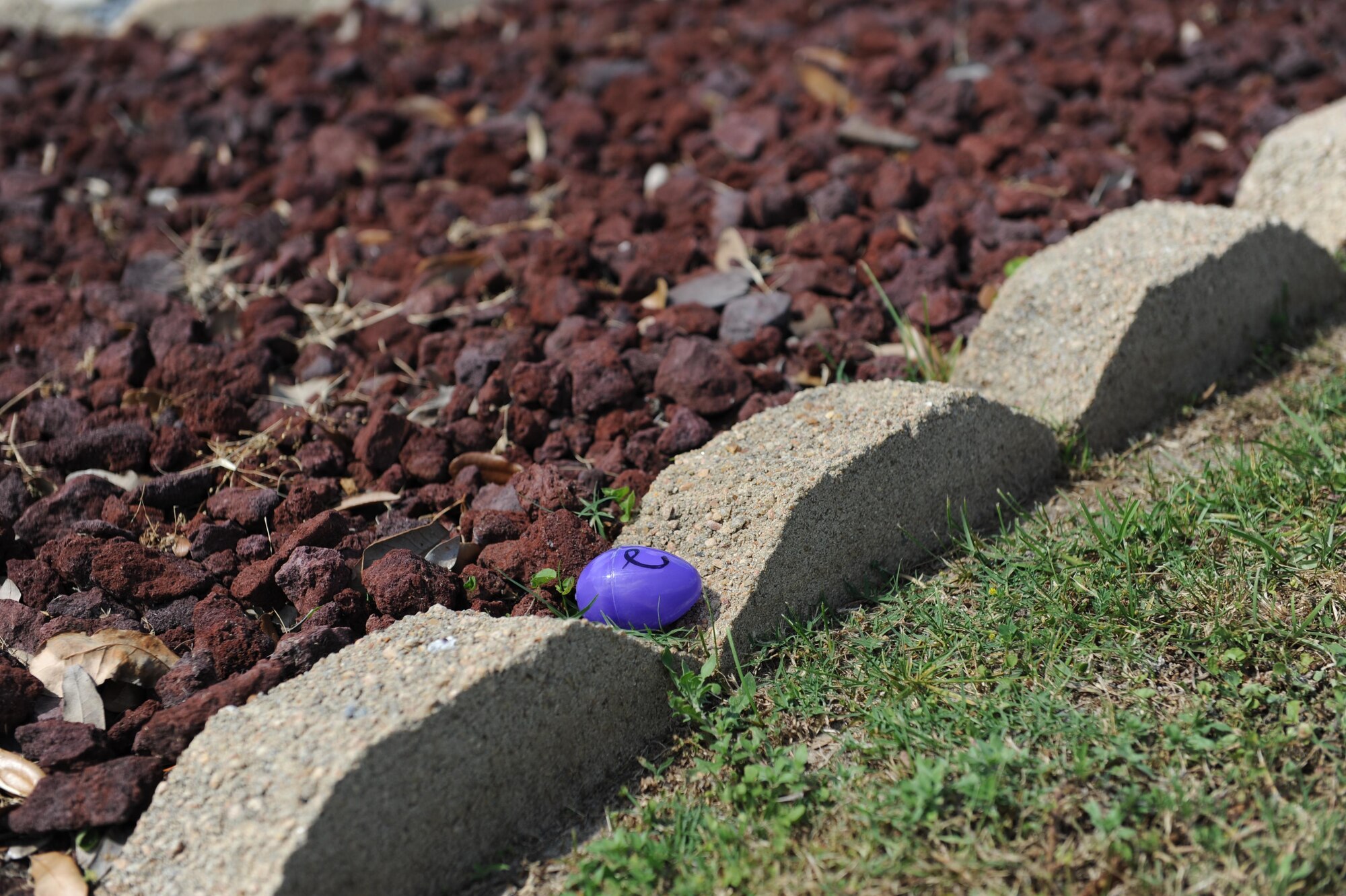A plastic egg containing a clue sits near Cody Hall during the Wingman Week Heritage Hunt April 26, 2016, Keesler Air Force Base, Miss. The hunt, consisting of eight teams, was one of many events held throughout the week. The “Training Group-A” team was the winner of the event. (U.S. Air Force photo by Kemberly Groue)